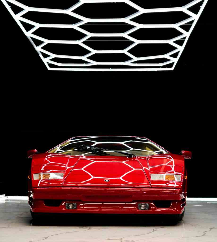 Red Lamborghini Countach front view under hex studio lighting